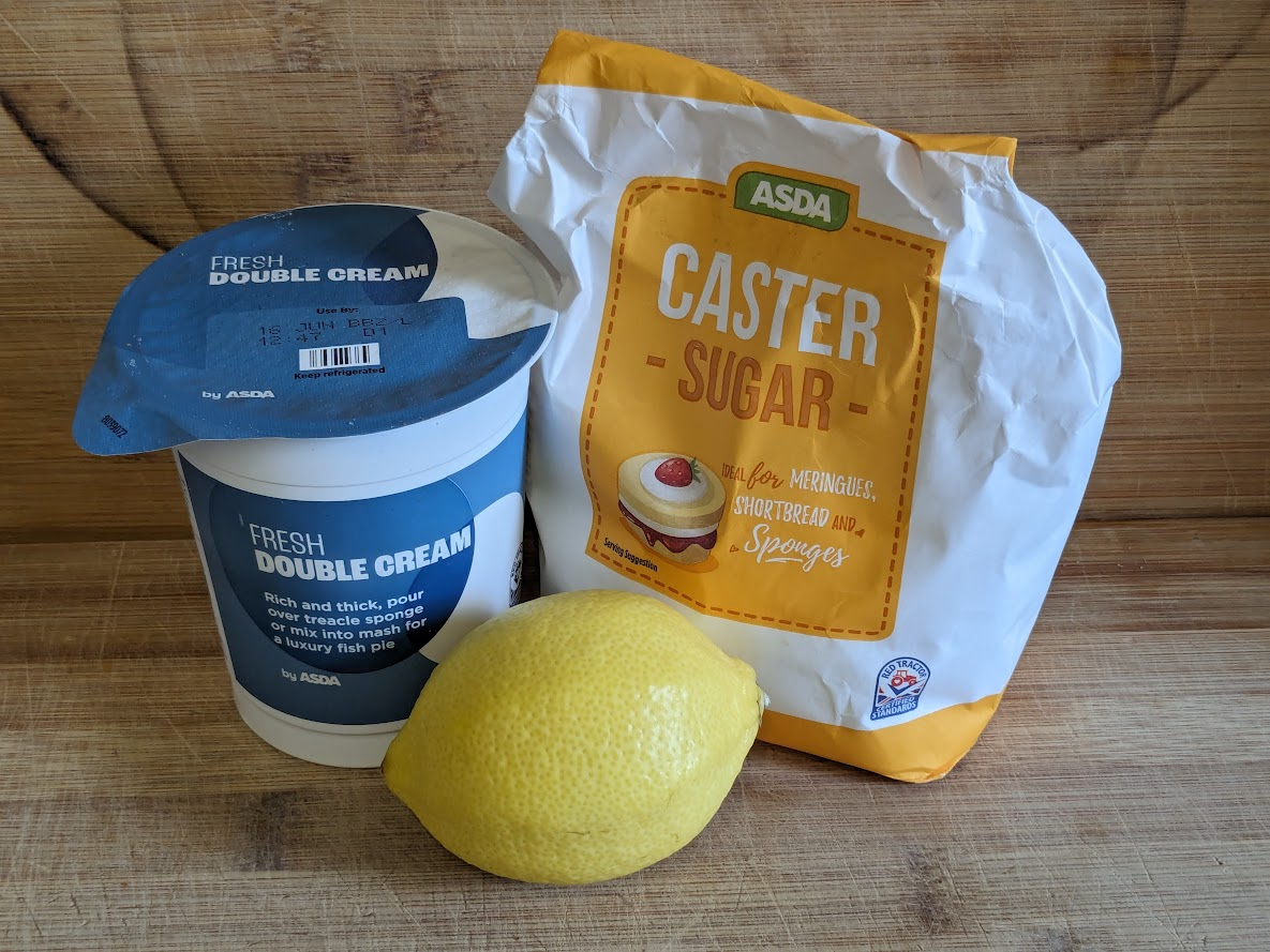 Picture of a pot of double cream, half a bag of sugar, and a lemon.